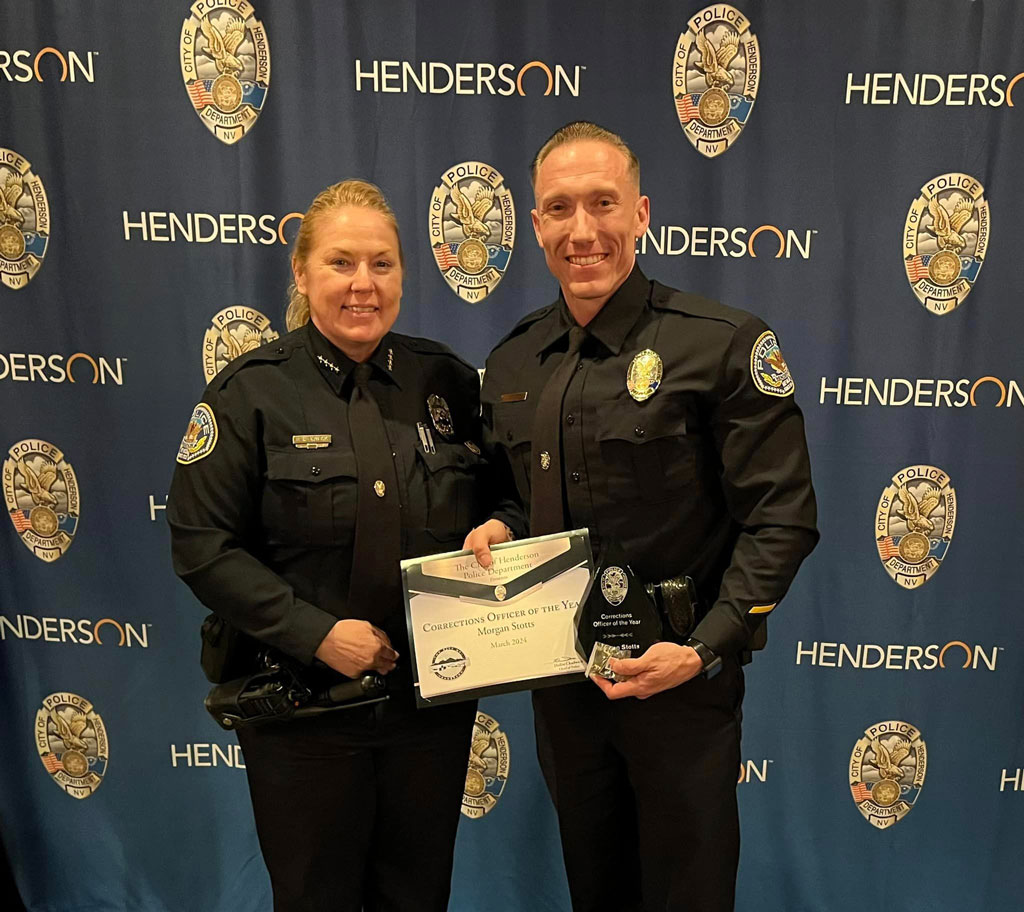 An Image of the Henderson Police Department's Correction Officer Morgan Stotts being handed with a Certificate